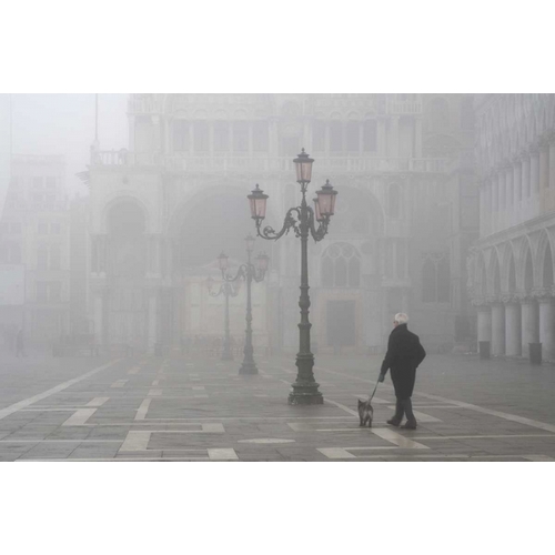 Italy, Venice A man walks his dog in fog